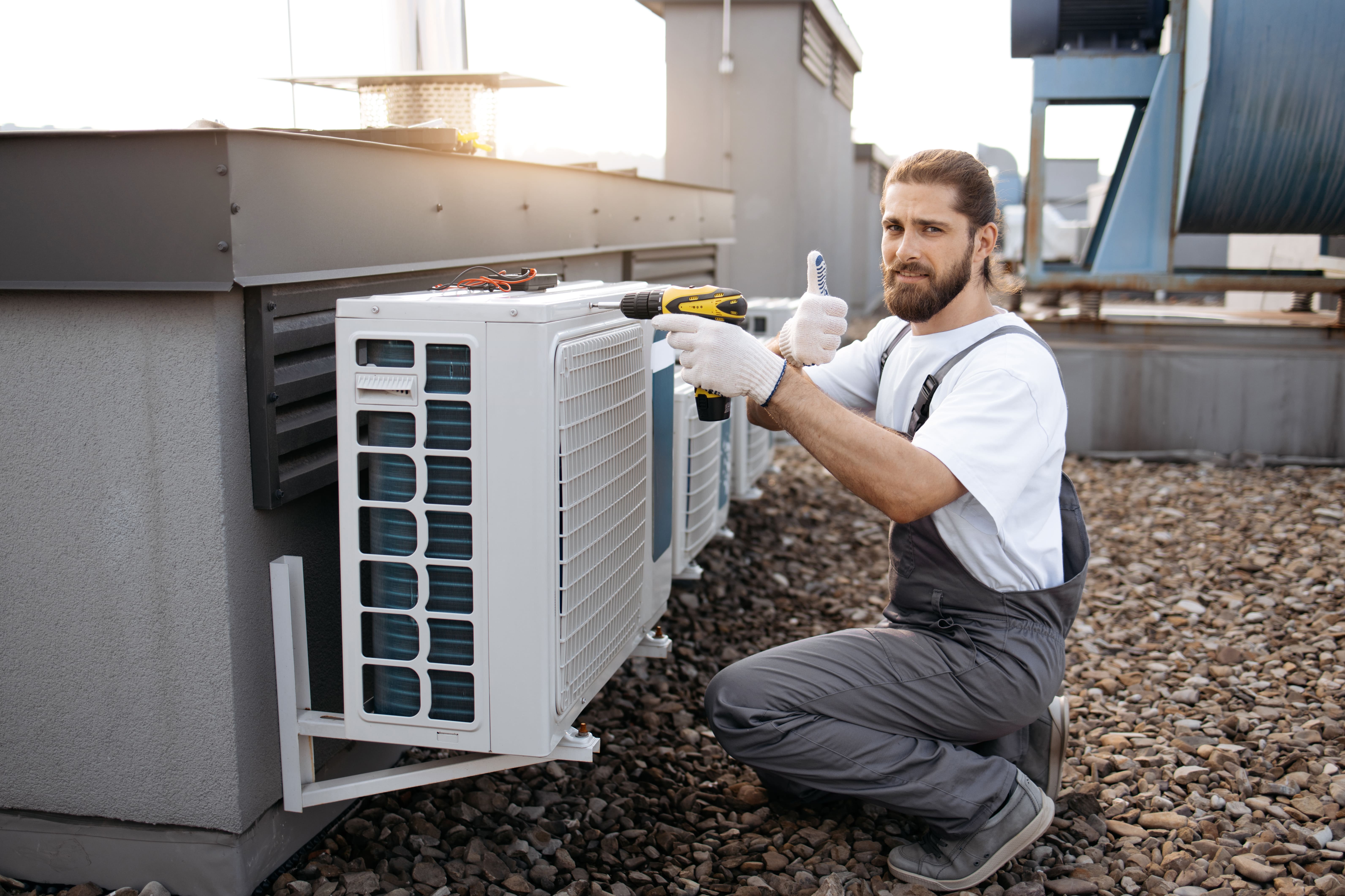 A VennAIR partner technician working on an outdoor AC unit